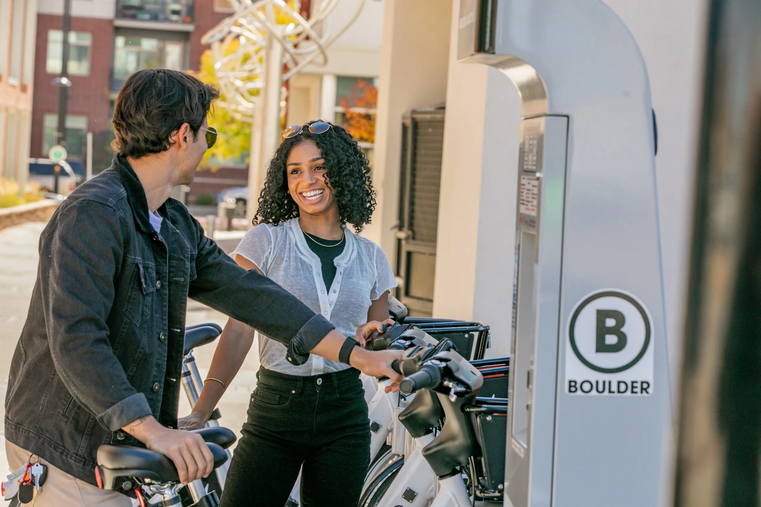 Couple standing a bike share station