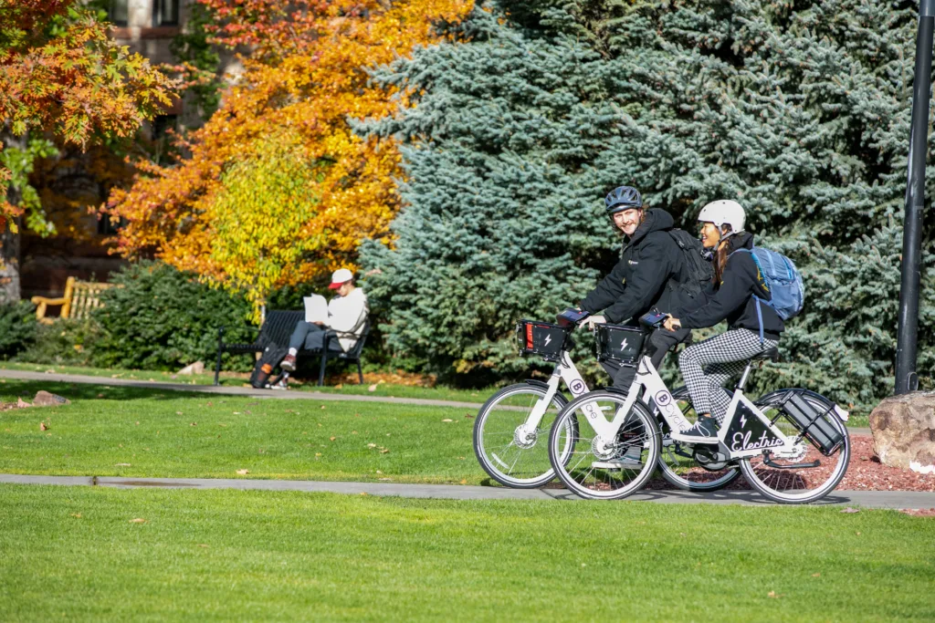 students riding bike share bicycles in Boulder, Co.