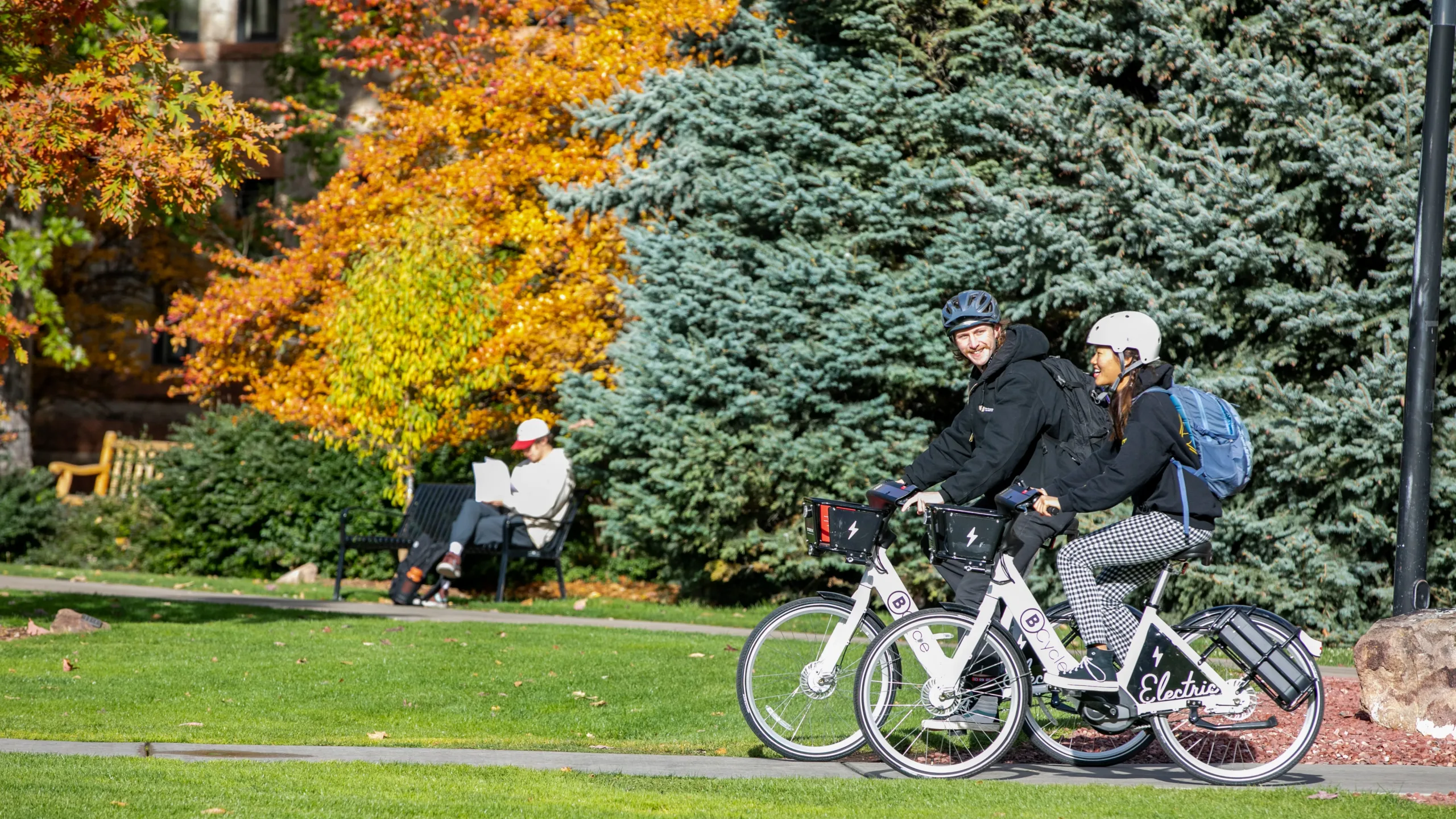students riding bike share bicycles in Boulder, Co.