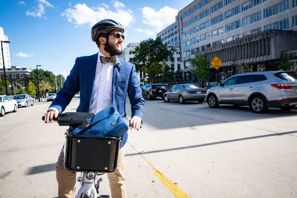 Man with a helmet riding a BCycle bike share bicycle