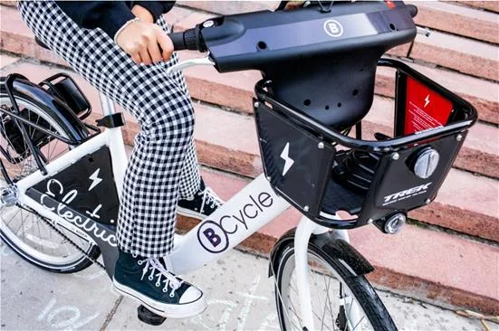 Woman about to ride a bike share bicycle